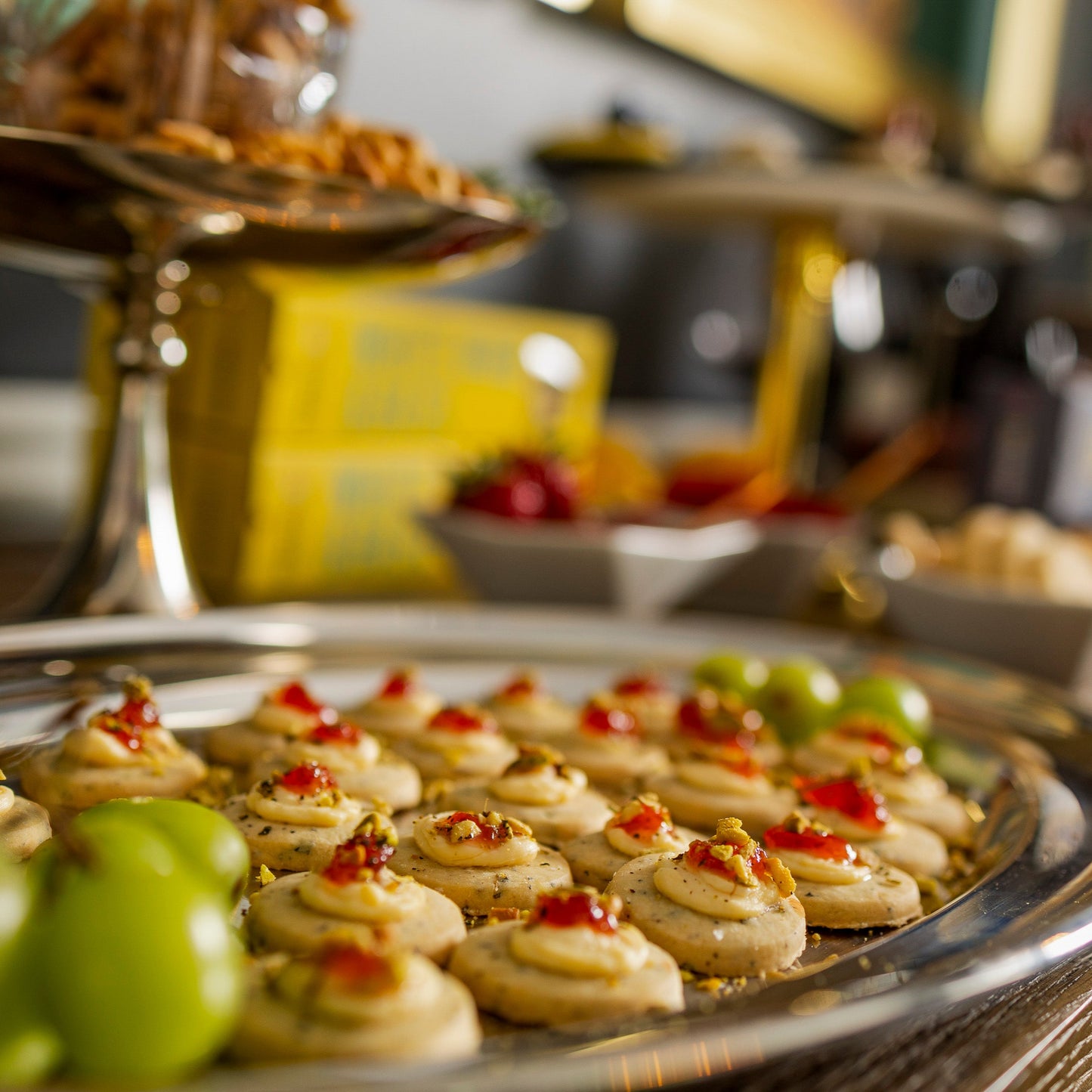 Platter of appetizers with grapes on a wooden table