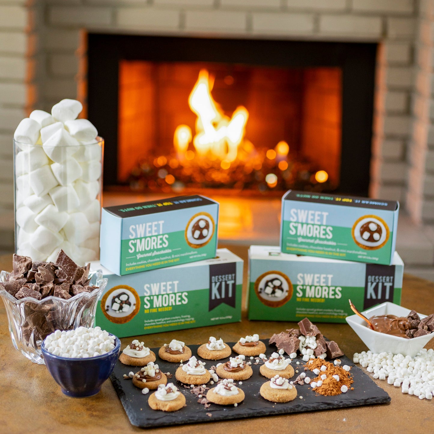 S'mores kit with marshmallows and chocolate bars in front of a fireplace