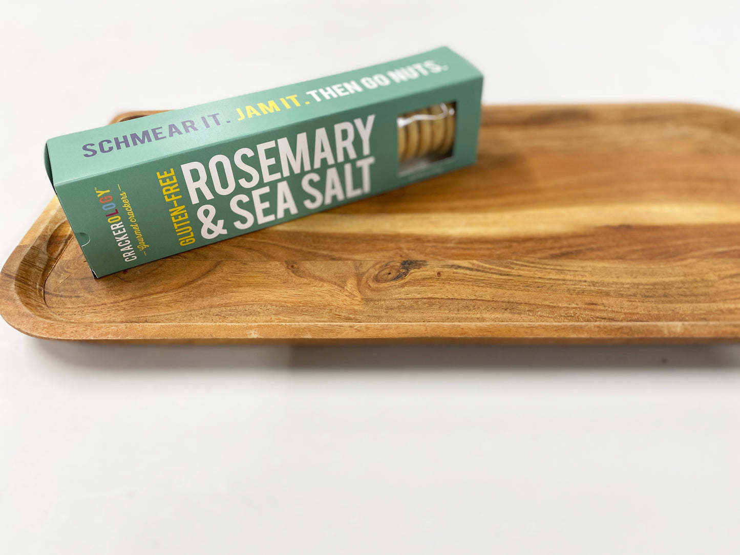 Gluten Free Crackers of Rosemary & Sea Salt on a wooden tray.